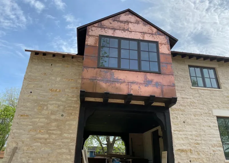 Copper metal panel facade on a stone building for Skylight Installation in Westville