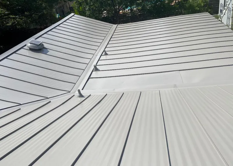 Solar attic fan installed on a metal roof for Roof Ventilation in Westville